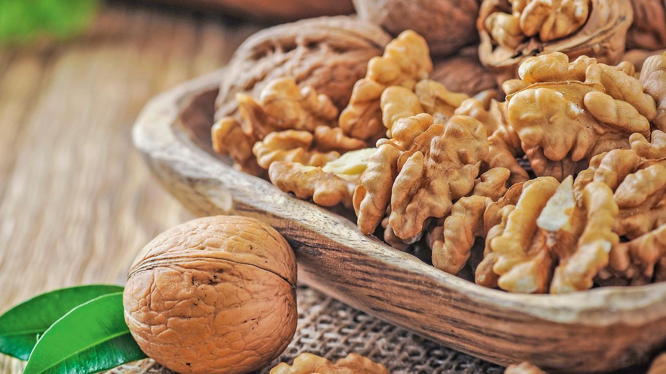 Walnuts,In,Wooden,Bowl.,Whole,Walnut,On,Wood,Table,With