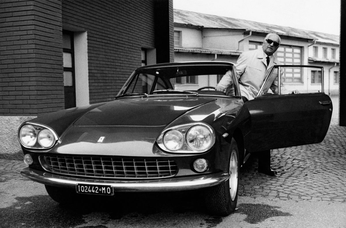 Enzo Ferrari with a Ferrari car