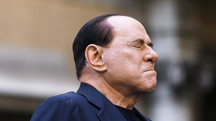 Former Italian Prime Minister Silvio Berlusconi closes his eyes in a gesture to supporters during a rally to protest his tax fraud conviction, outside his palace in central Rome