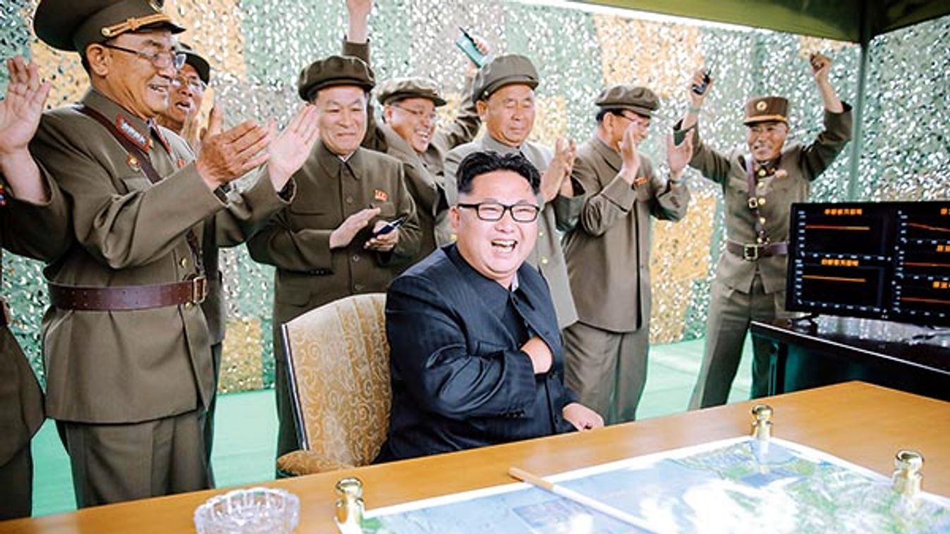 North Korean leader Kim Jong Un reacts during a test launch of ground-to-ground medium long-range ballistic rocket Hwasong-10 