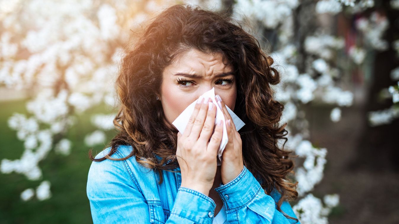Young,Woman,Sneezing,In,Park.,Allergy,,Flu,,Virus,Concept.