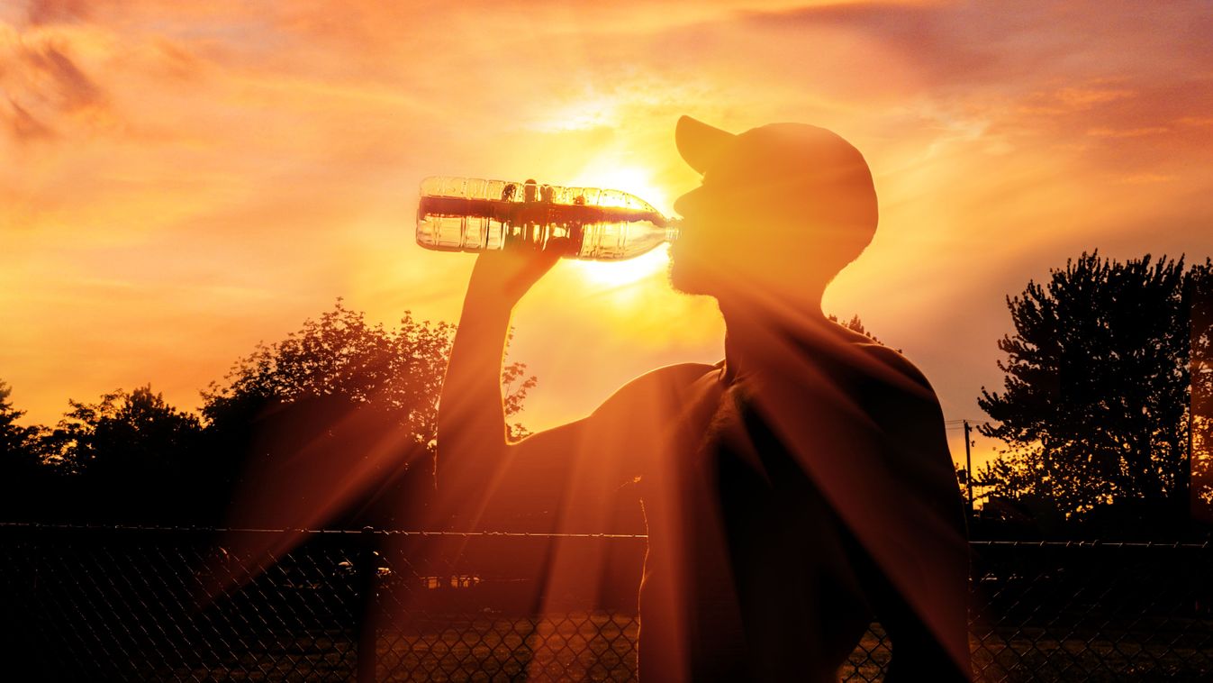 Silhouette,Of,A,Man,Drinking,Water,During,Heat,Wave