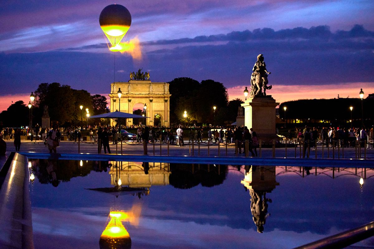 The Cauldron With The Olympic Flame Lit Flies Seen From The Louvre