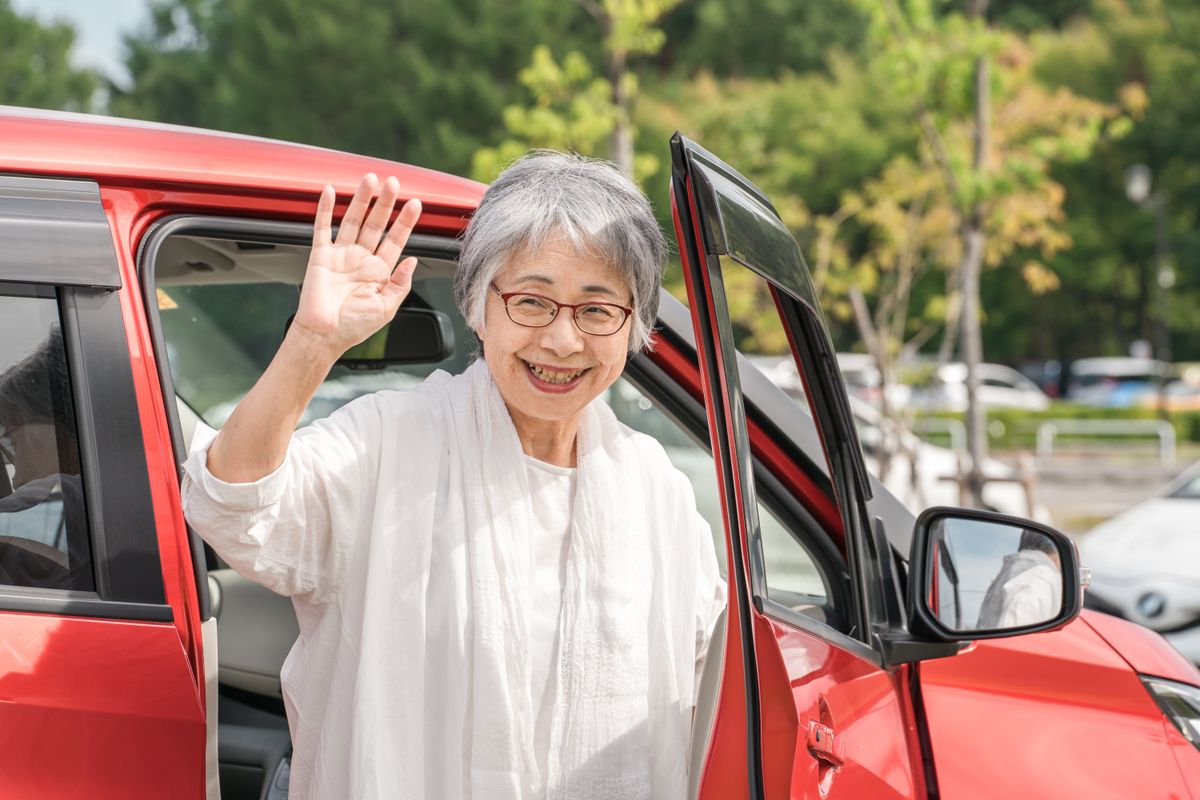 An,Elderly,Female,Driver,Gets,Out,Of,The,Car,And