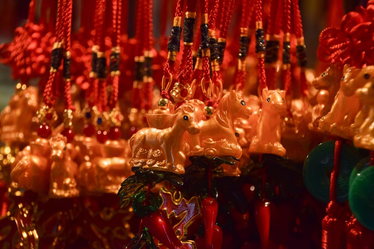 Horse-themed lucky charms are displayed for sale in a
