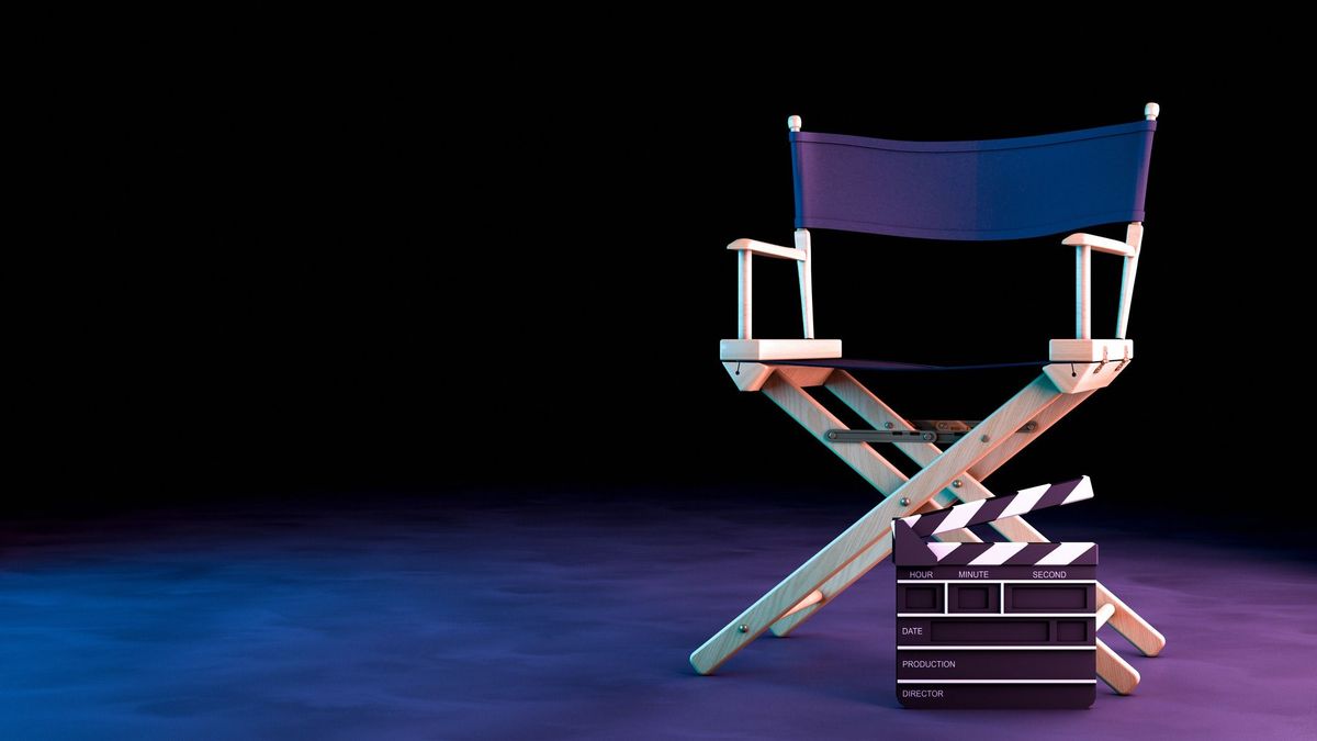 Director Chair and Movie Clapper with neon lights on black background