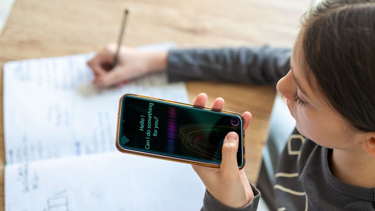 Young girl uses AI virtual assistant to do schoolwork