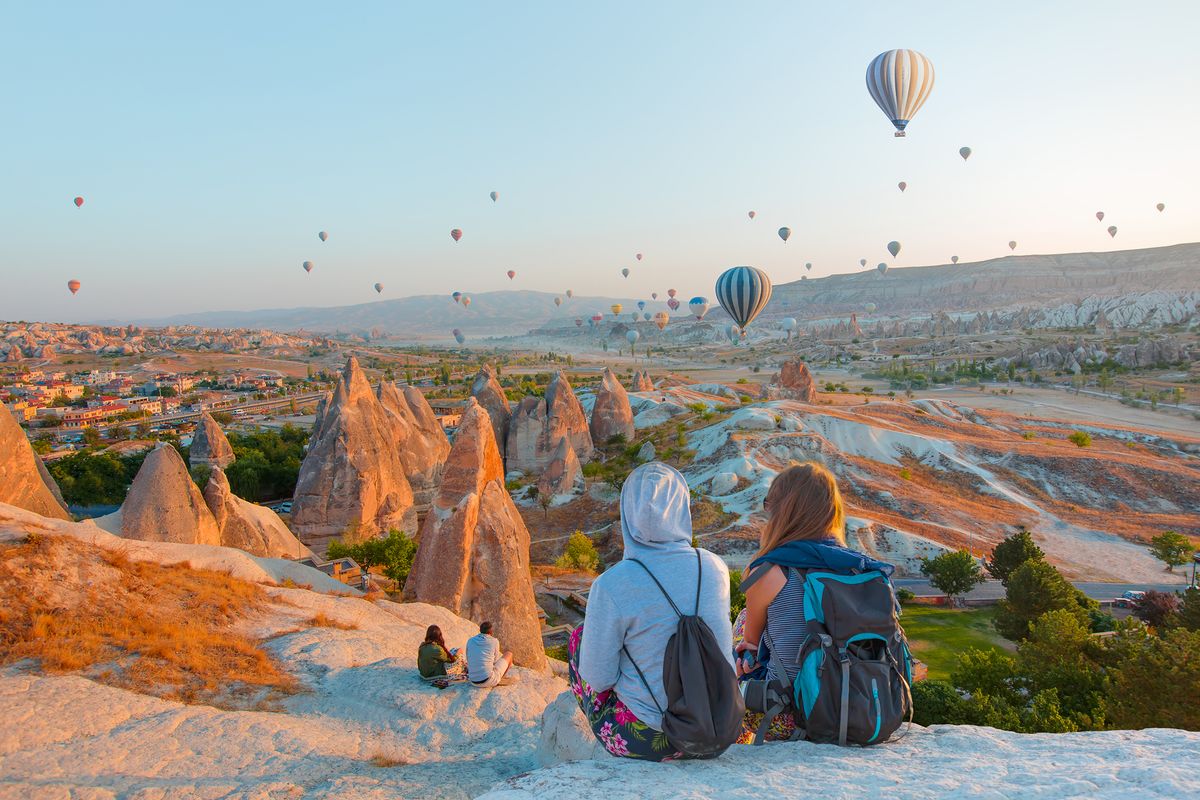 Hot,Air,Balloon,Flying,Over,Spectacular,Cappadocia,-,Girls,Watching