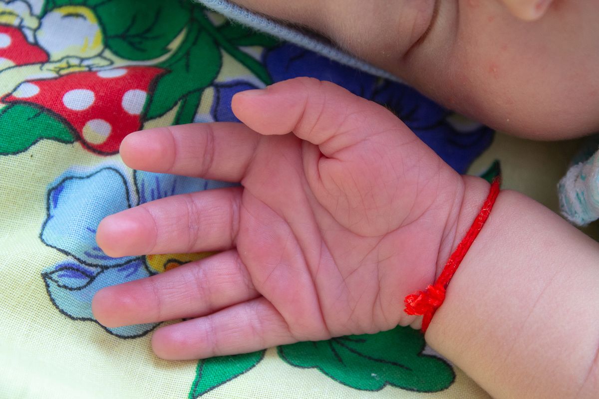 Baby,Hand,With,Thread,sleeping,Baby,With,Red,Thread,On,His
