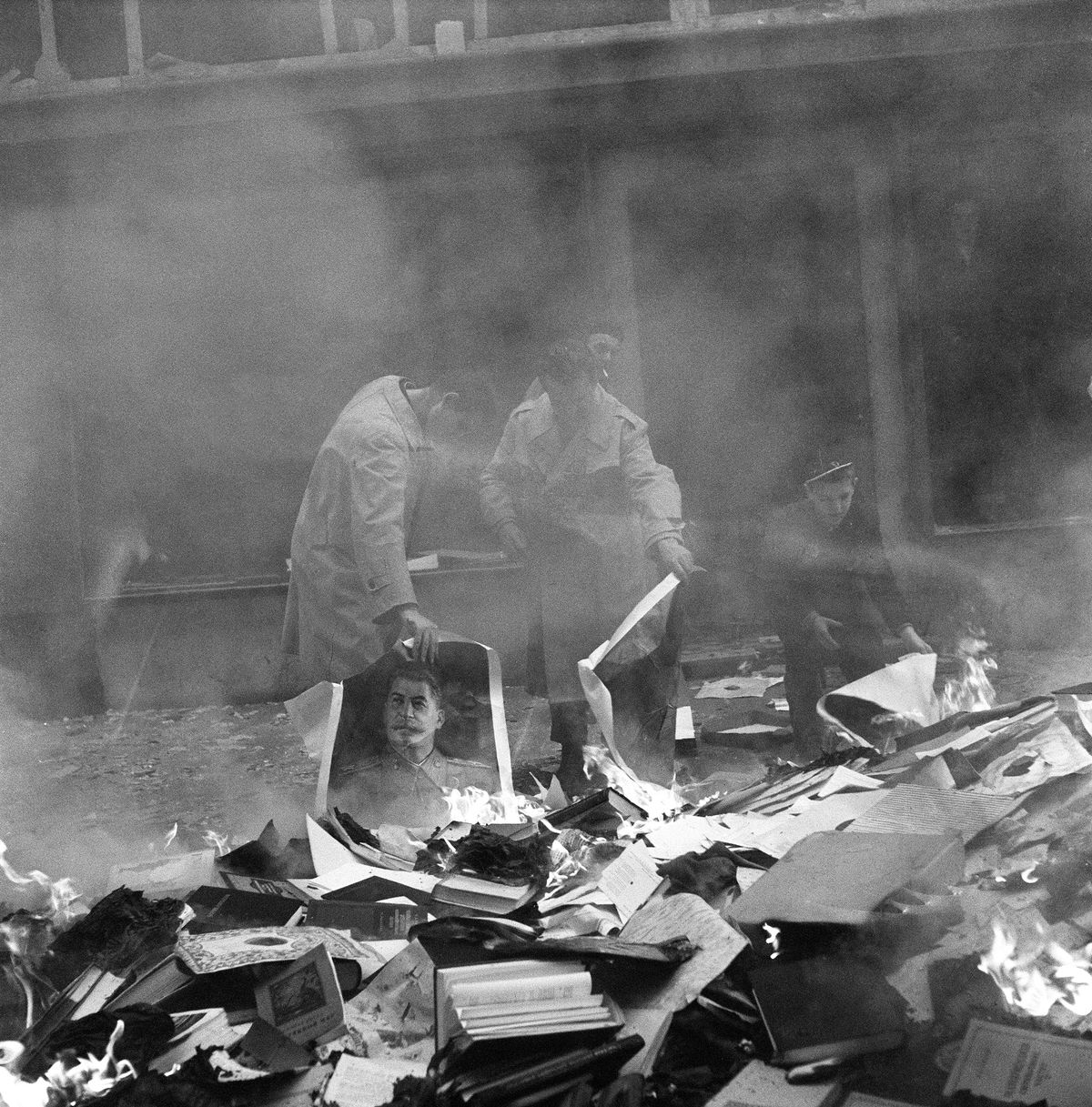 Hungarian people burning pictures of Stalin and books from a ransacked Russian bookshop Budapest, Hungary October 1956